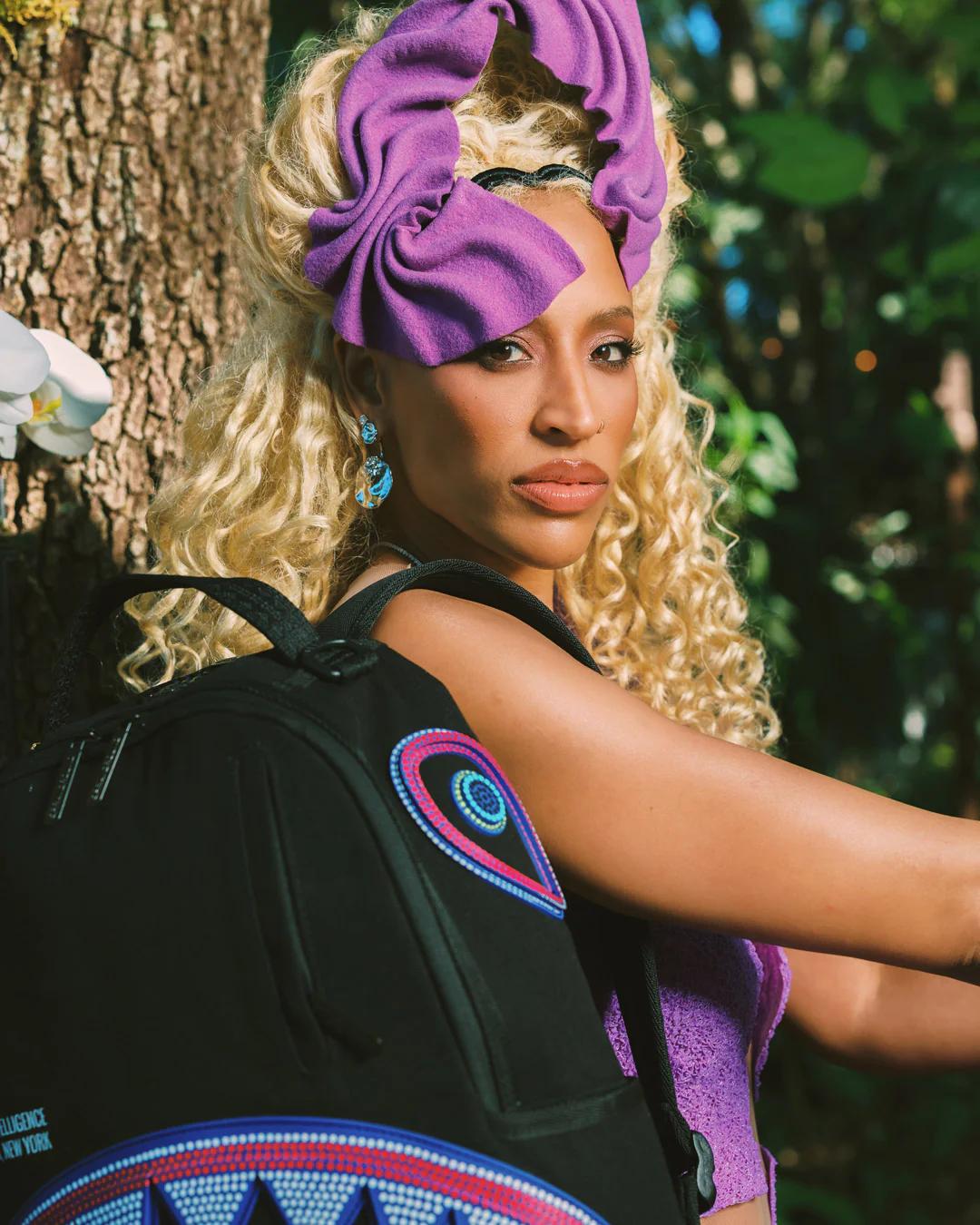 Sprayground A.I. AFRICAN INTELLIGENCE BORN AND RAISED BACKPACK - SANDFLOWER COLLAB