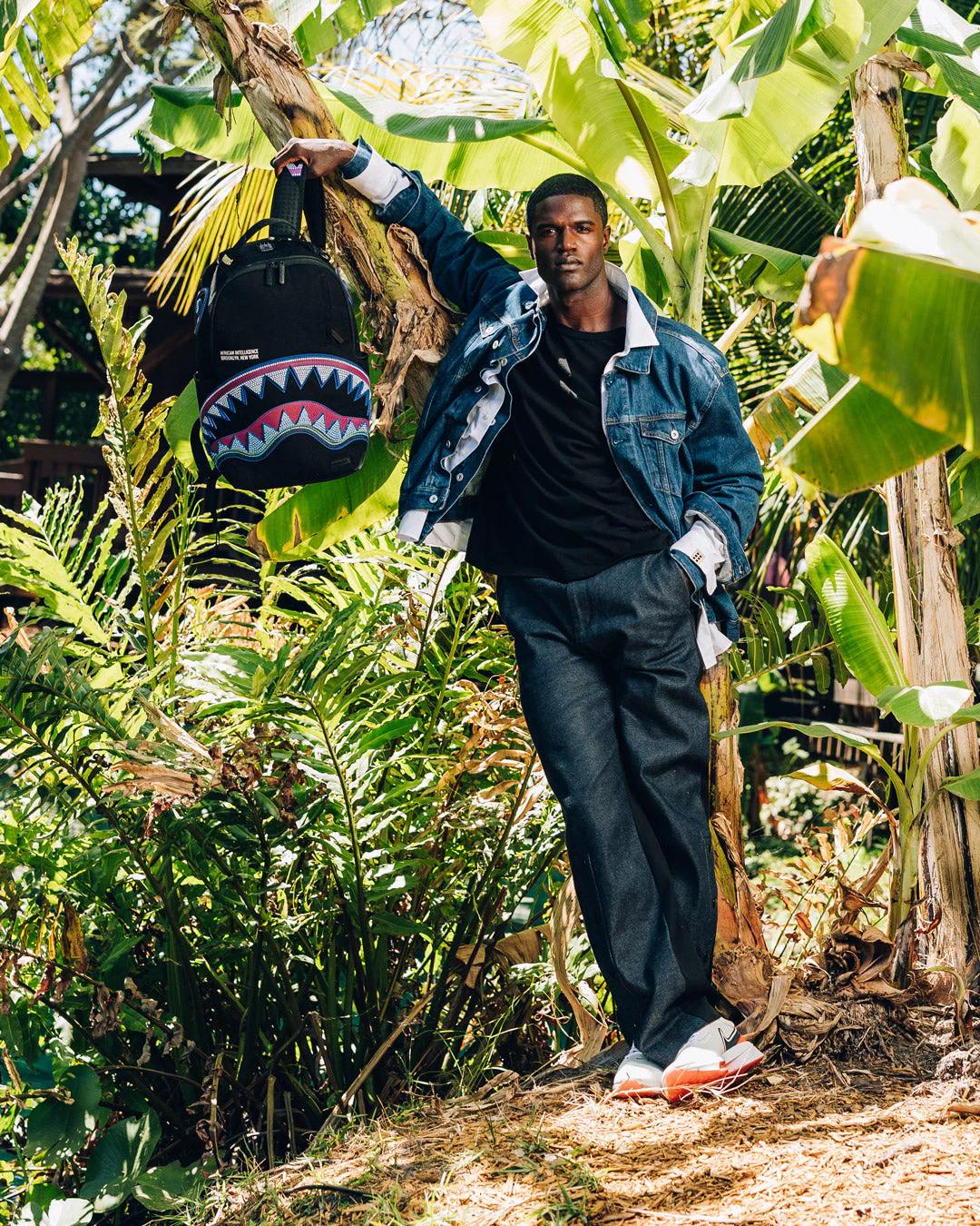 Sprayground A.I. AFRICAN INTELLIGENCE BORN AND RAISED BACKPACK - SANDFLOWER COLLAB