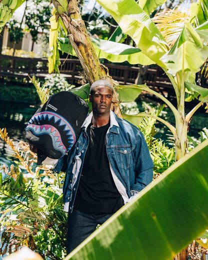 Sprayground A.I. AFRICAN INTELLIGENCE BORN AND RAISED BACKPACK - SANDFLOWER COLLAB