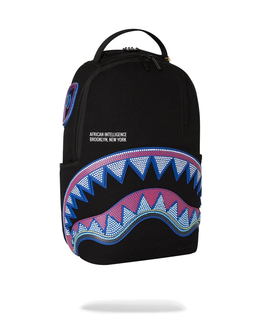 Sprayground A.I. AFRICAN INTELLIGENCE BORN AND RAISED BACKPACK - SANDFLOWER COLLAB