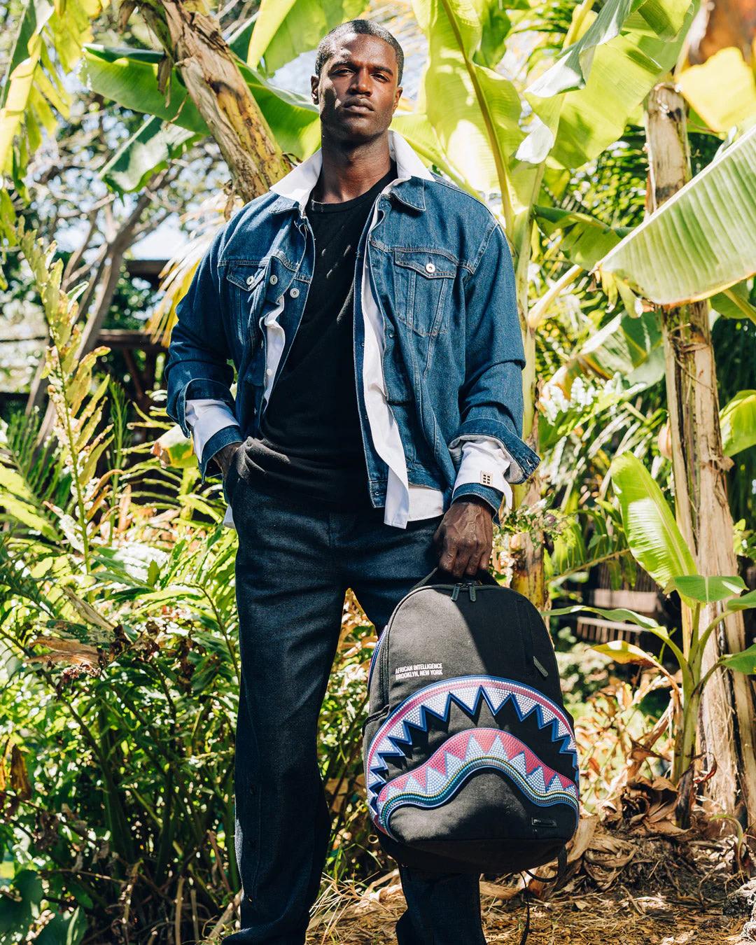 Sprayground A.I. AFRICAN INTELLIGENCE BORN AND RAISED BACKPACK - SANDFLOWER COLLAB